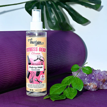 Plant-based yoga mat cleaner spray being used on a rolled-out PVC mat – eco-friendly and anti-bacterial disinfectant for fitness use